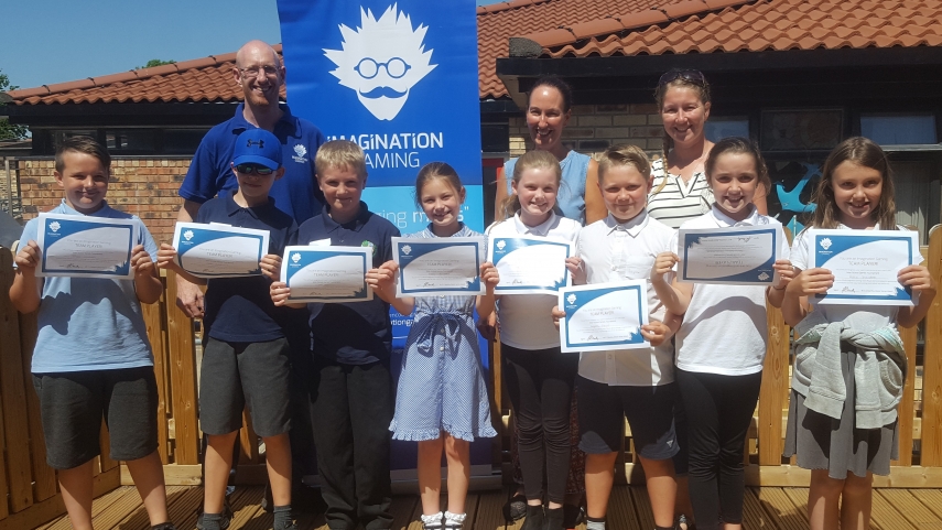 Eight children with certificates, two teaching staff and one Imagination Gaming member of staff