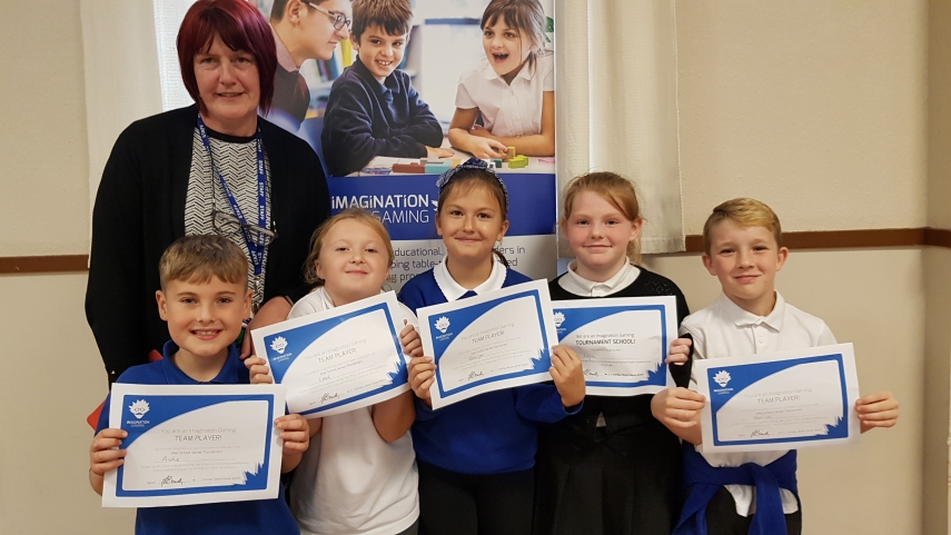 Five children and one teacher holding certificates