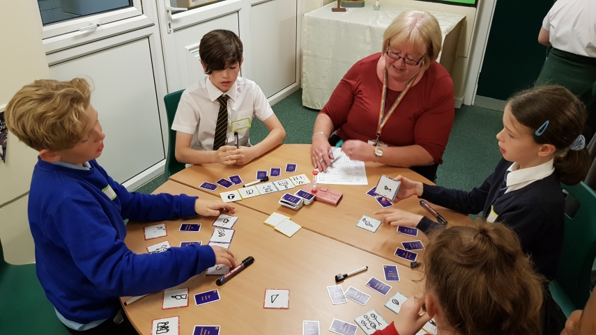 Teacher and pupils playing card game