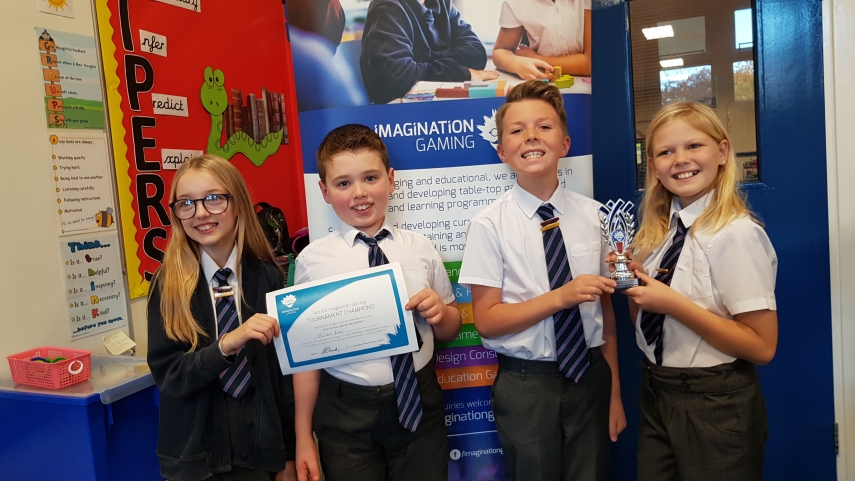 four children with certificate and Imagination Gaming trophy