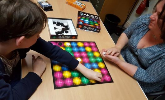 Boy and woman playing Qango board game