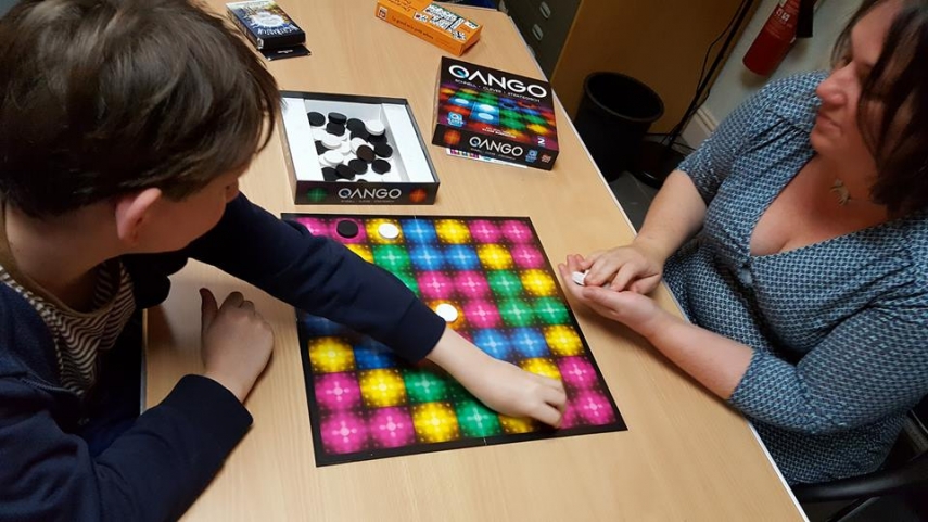 Boy and woman playing Qango board game