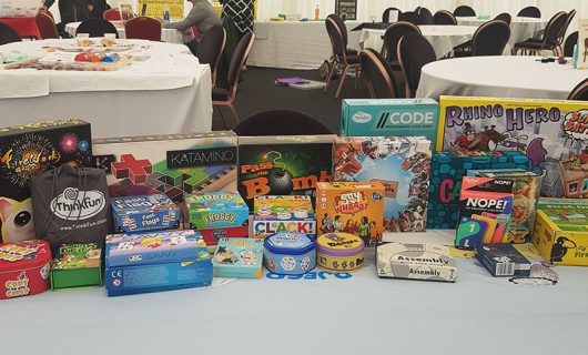 A variety of board games and card games displayed on a table