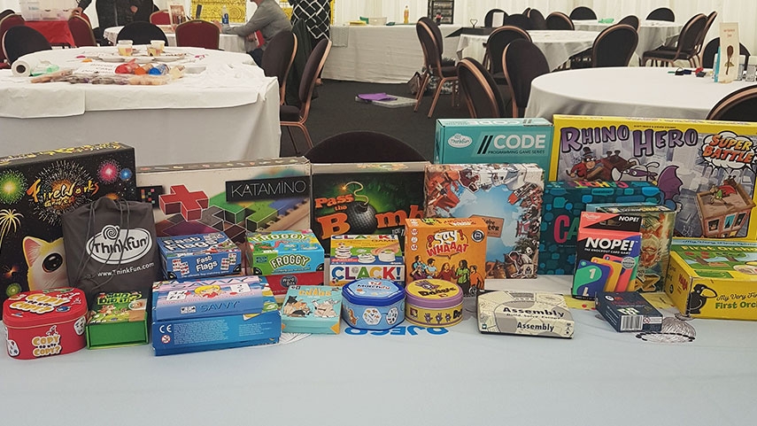 A variety of board games and card games displayed on a table