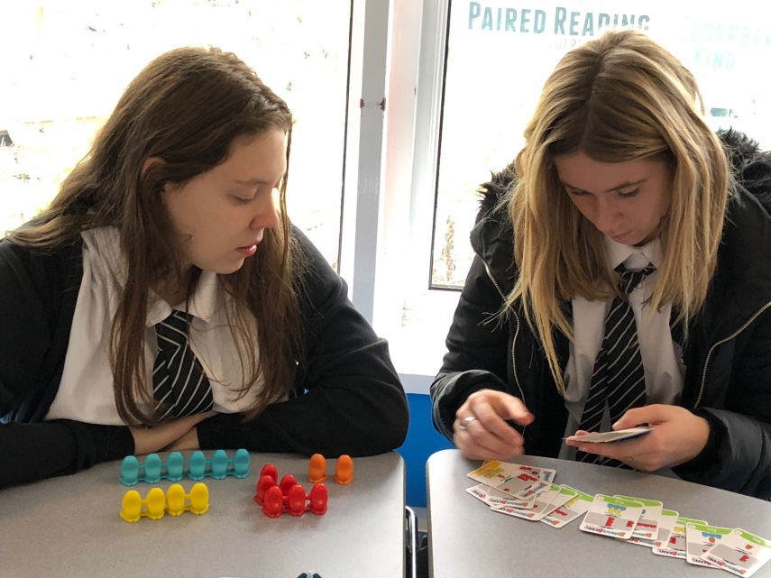 Two girls playing a card game