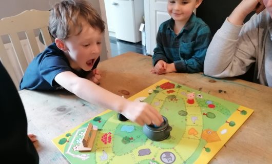 Young boy playing board game