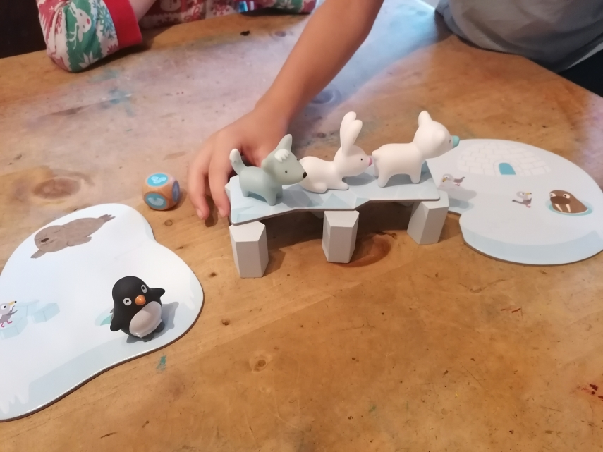 Game pieces including penguin, rabbit, polar bear.