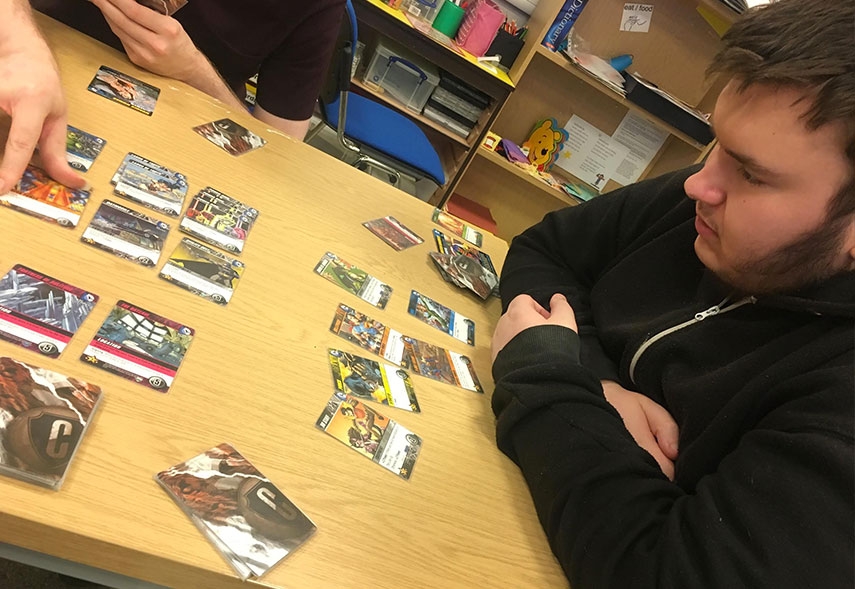 Teenager playing a card game