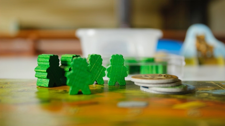 Meeples game pieces on a game board