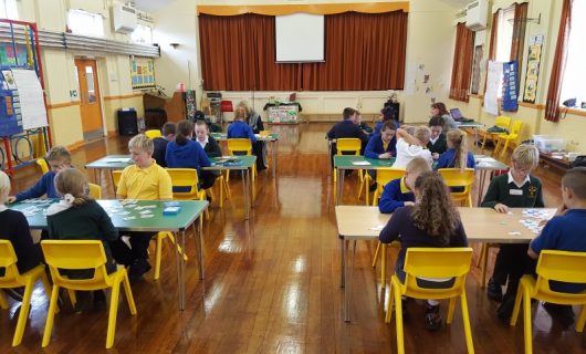 Children sat at desks playing games